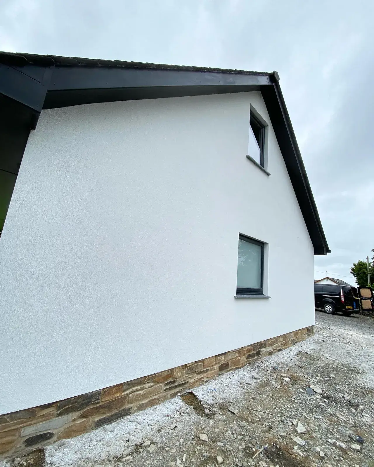 Home finished in white silicone render with a crisp rendered gable, by PureRend