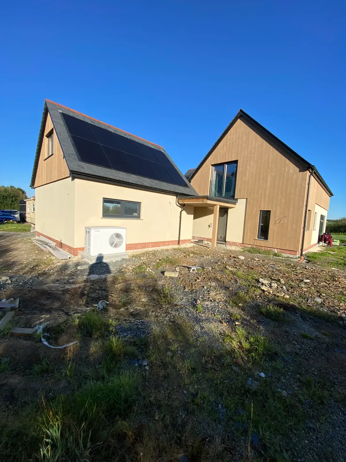 Detached home finished in buff monocouche render with a clean gable, by PureRend