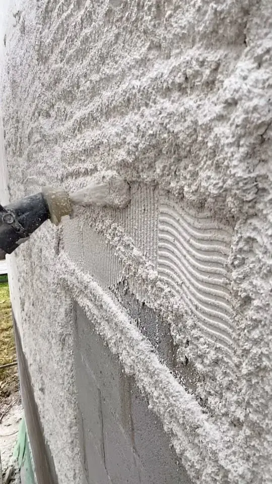 Silicone render being applied by hand over a fibreglass-mesh basecoat on a North Cornwall property